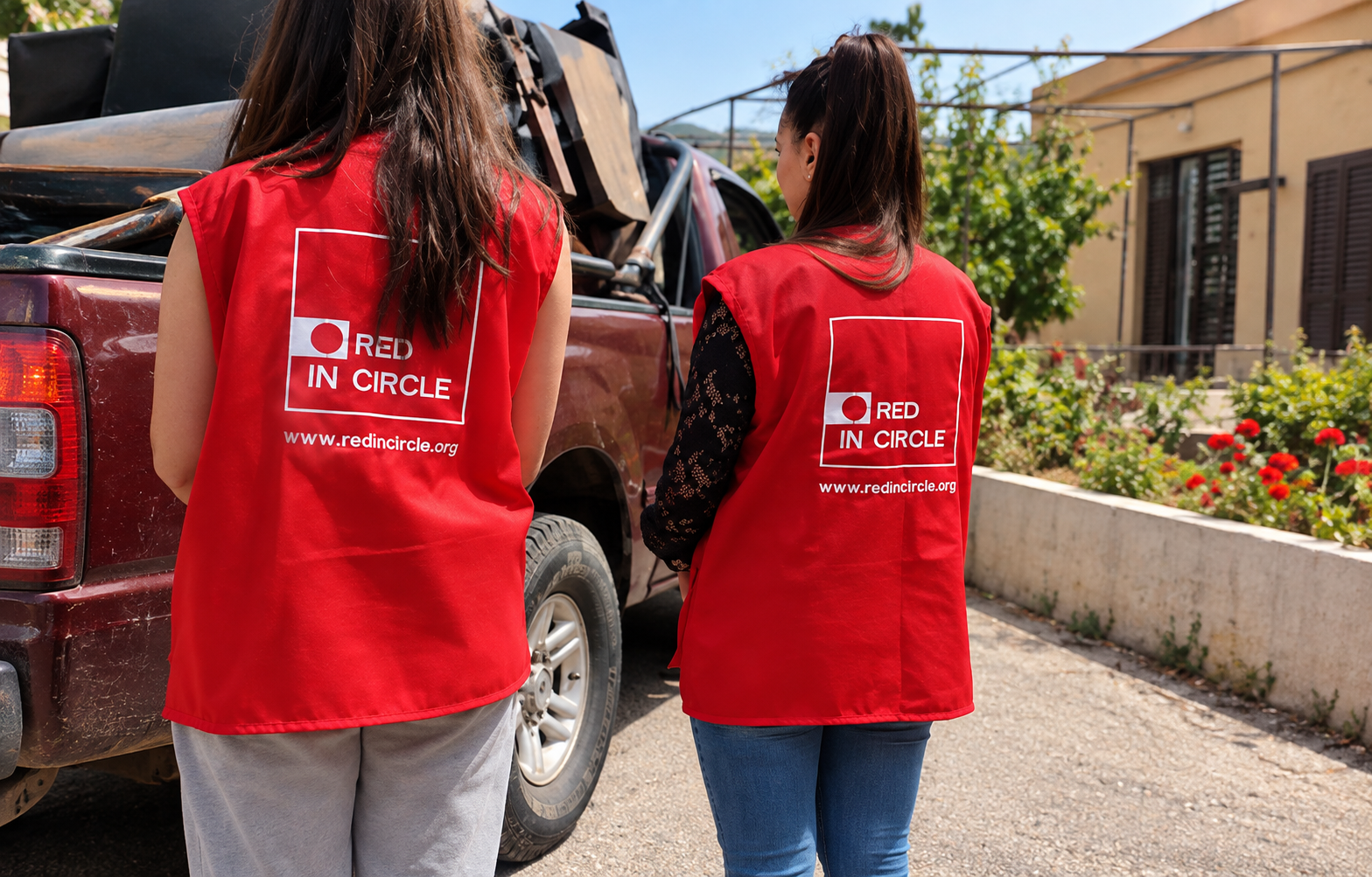 Red In Circle volunteers wearing red vests prepare to deliver humanitarian aid and supplies to families in need.